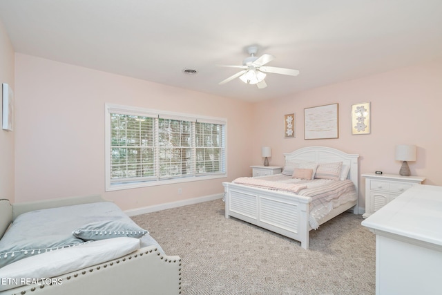 bedroom featuring ceiling fan and light carpet