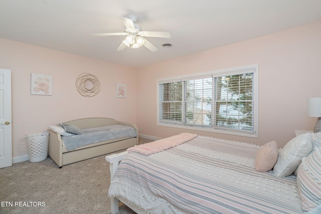 bedroom featuring ceiling fan and light carpet