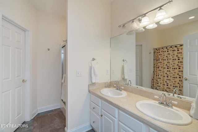 bathroom featuring tile patterned floors, a shower, and vanity