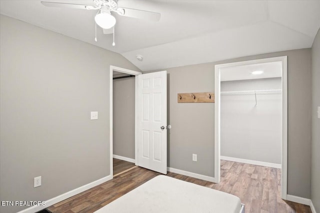 bedroom featuring hardwood / wood-style flooring, ceiling fan, vaulted ceiling, and a closet