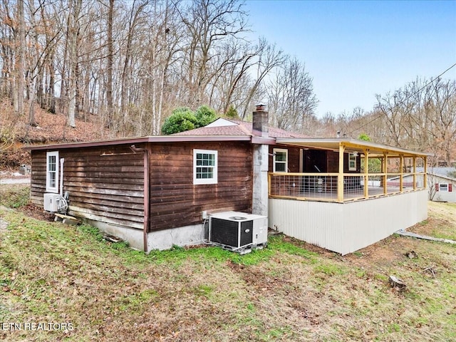 rear view of house with cooling unit