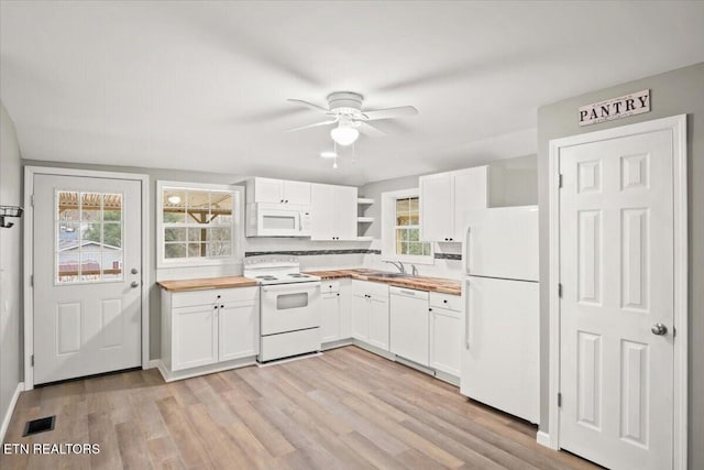 kitchen featuring white cabinets, white appliances, wood counters, and sink