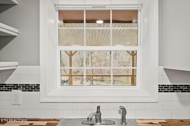 interior details featuring butcher block counters and sink