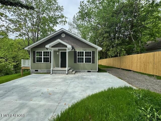 bungalow-style house with crawl space and fence