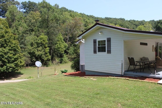 view of side of property with a yard