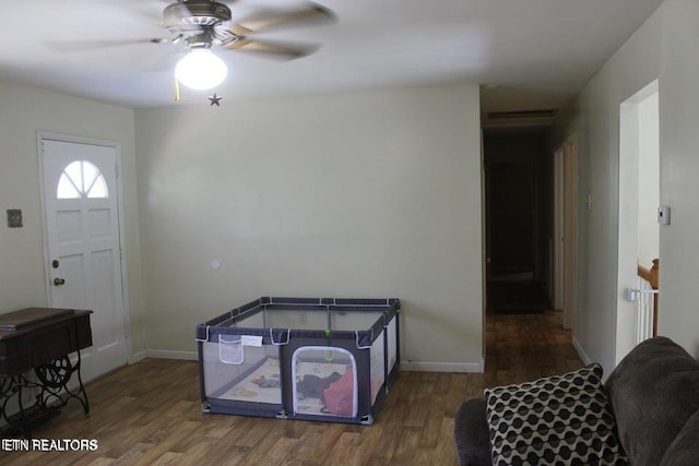 entryway with ceiling fan and dark wood-type flooring