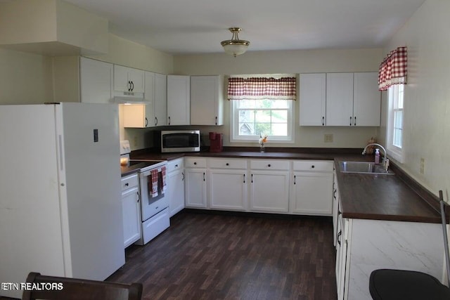 kitchen featuring white cabinetry, sink, dark hardwood / wood-style floors, and white appliances