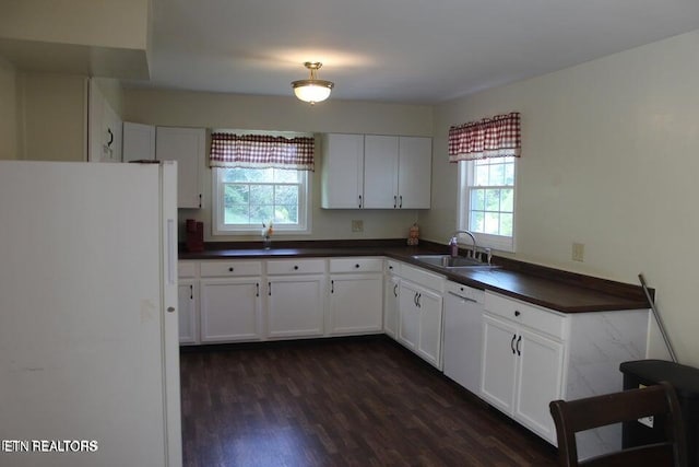 kitchen featuring white appliances, white cabinetry, and sink