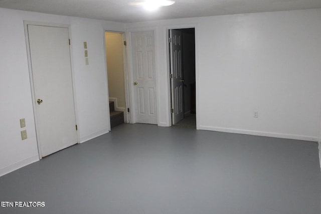 unfurnished bedroom with concrete flooring