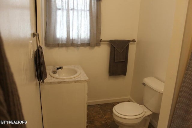 bathroom featuring tile patterned floors, vanity, and toilet