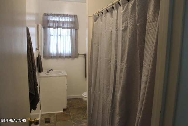 bathroom with vanity and toilet