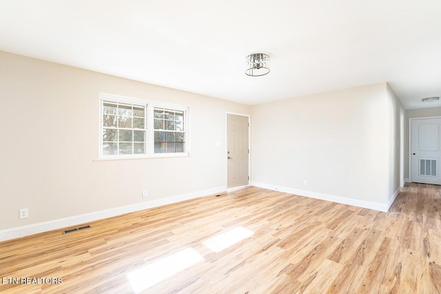 spare room with light hardwood / wood-style flooring