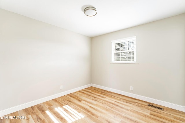 unfurnished room featuring hardwood / wood-style flooring