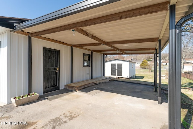 view of patio with a carport and a storage unit