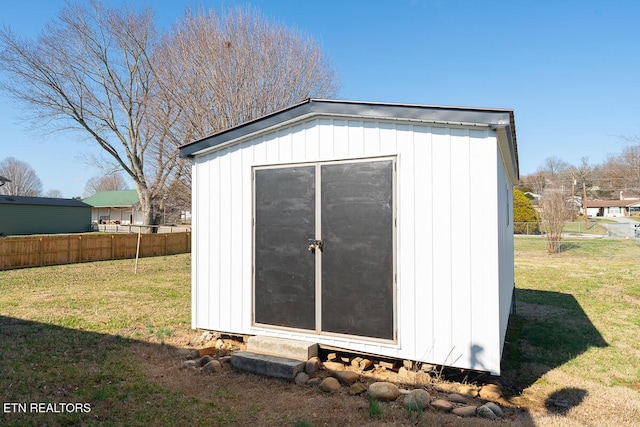 view of outbuilding with a lawn