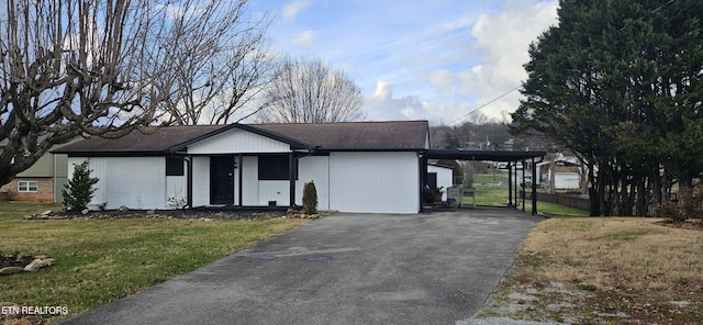 view of front of property with a front yard and a carport