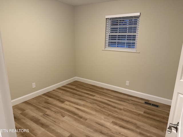 empty room featuring hardwood / wood-style flooring