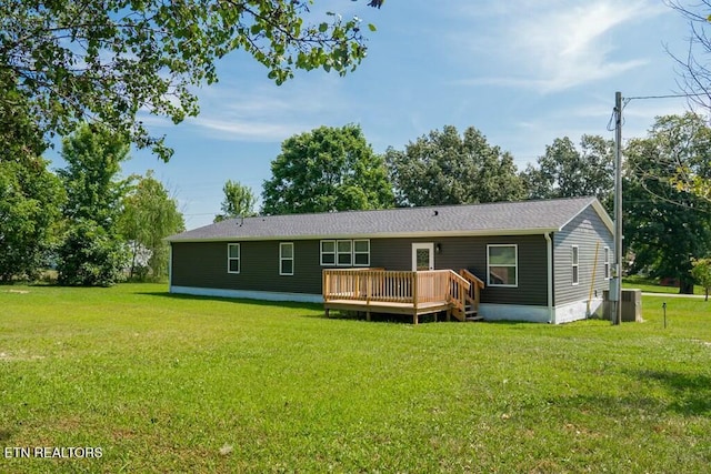 back of house featuring a wooden deck, a yard, and central AC