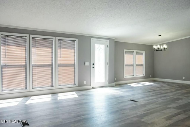 interior space featuring a chandelier, hardwood / wood-style floors, and a textured ceiling