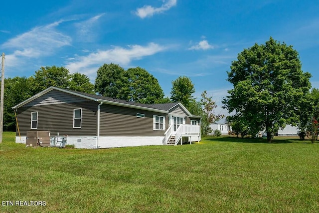 back of property featuring a lawn