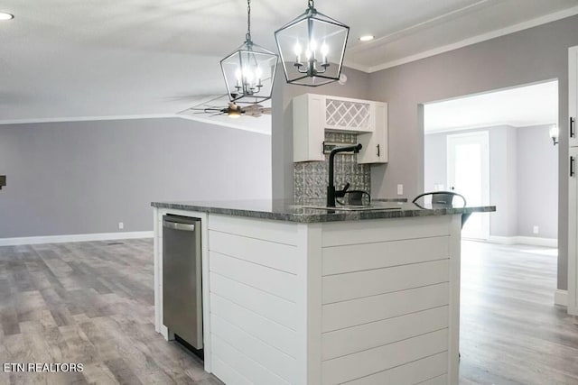 kitchen with pendant lighting, white cabinets, sink, ceiling fan, and ornamental molding