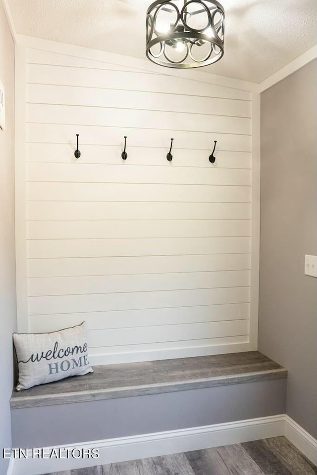 mudroom featuring dark hardwood / wood-style floors and a textured ceiling