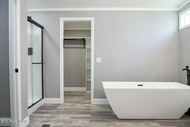 bathroom featuring hardwood / wood-style flooring and independent shower and bath