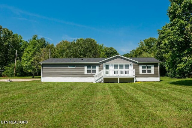 rear view of house with a yard