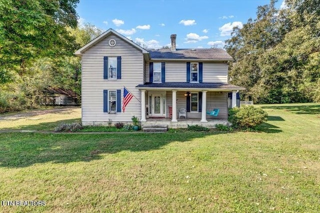 front of property featuring covered porch and a front lawn