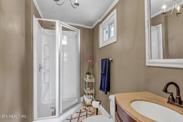 bathroom with vanity, an inviting chandelier, a shower with door, and ornamental molding