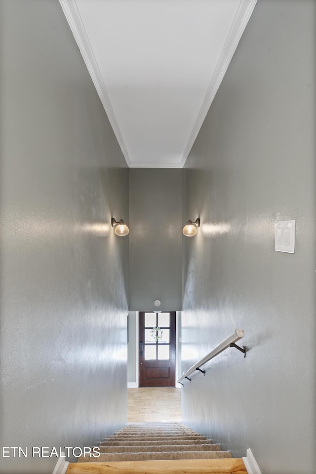 stairway featuring ornamental molding