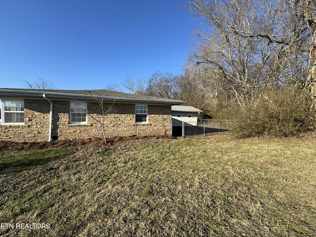 view of side of home with a lawn