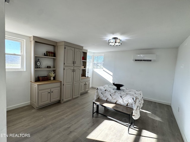 dining room with a wall mounted air conditioner and hardwood / wood-style flooring