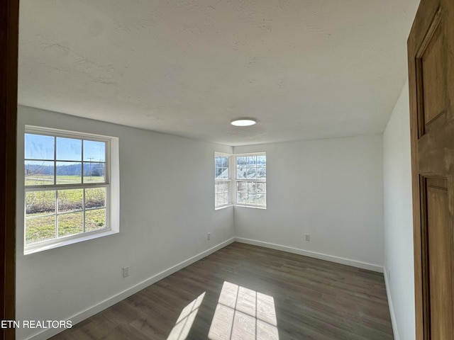 spare room featuring dark hardwood / wood-style floors