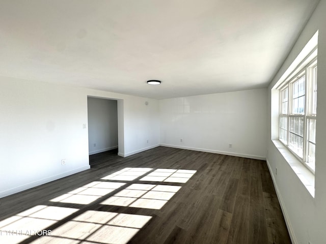 unfurnished room with dark hardwood / wood-style floors