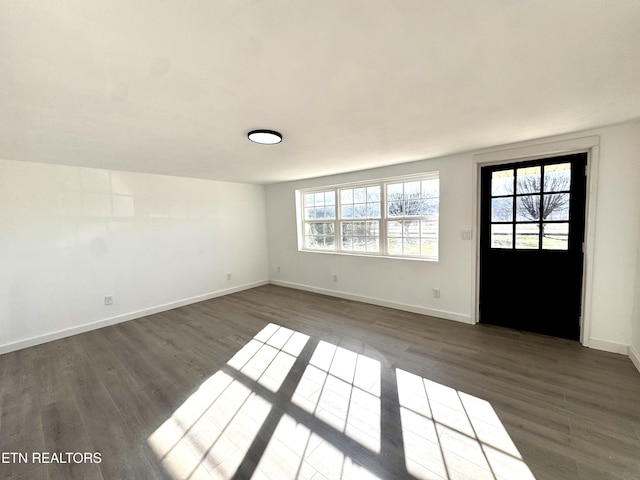 spare room with dark hardwood / wood-style flooring