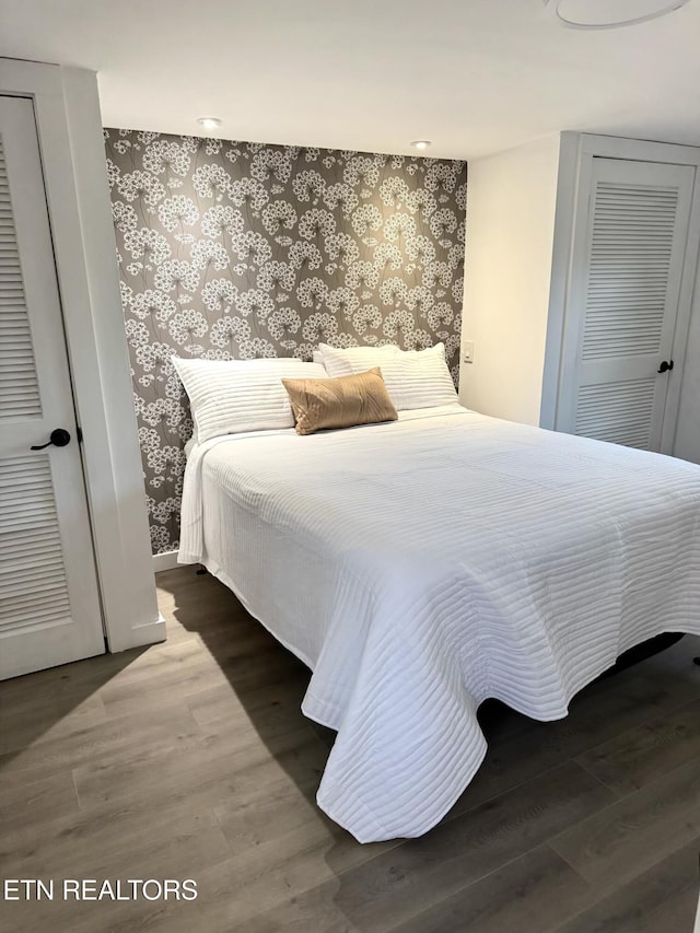 bedroom with hardwood / wood-style flooring and a closet