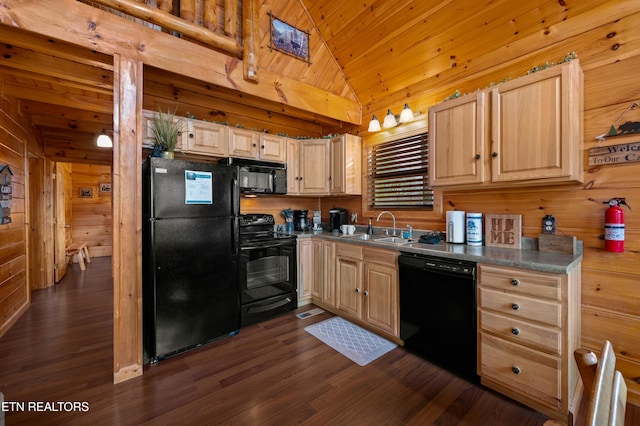 kitchen featuring lofted ceiling, sink, wooden walls, black appliances, and light brown cabinets