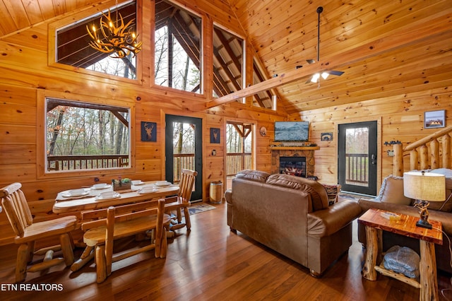 living room featuring high vaulted ceiling, dark hardwood / wood-style floors, a fireplace, and wood ceiling