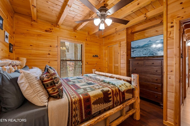 bedroom with ceiling fan, hardwood / wood-style floors, beam ceiling, wooden ceiling, and wood walls