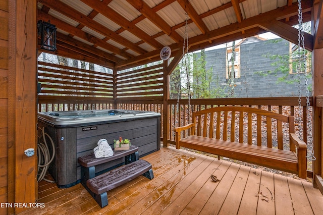 wooden deck with a hot tub