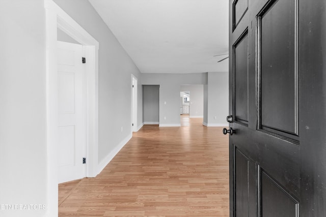 corridor with light wood-type flooring