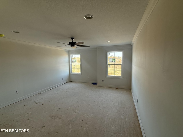 unfurnished room featuring a ceiling fan, crown molding, and baseboards