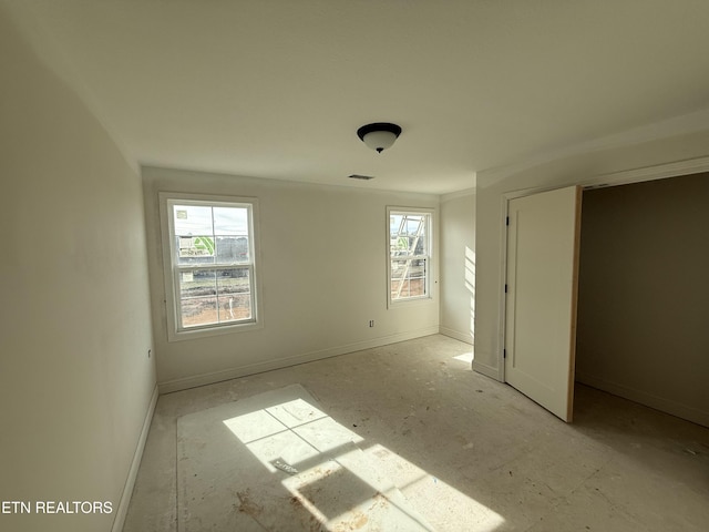 unfurnished bedroom featuring visible vents and baseboards