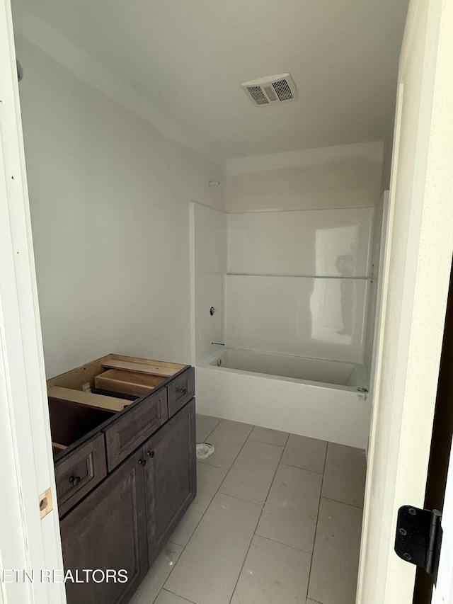 full bathroom with tile patterned flooring, vanity, visible vents, and shower / bathtub combination