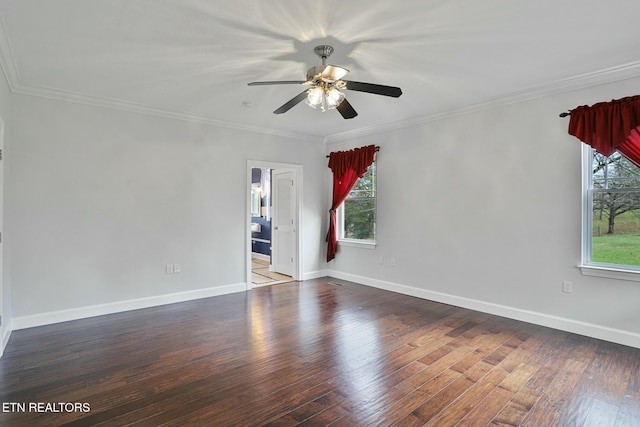 empty room with baseboards, ornamental molding, dark wood finished floors, and a ceiling fan