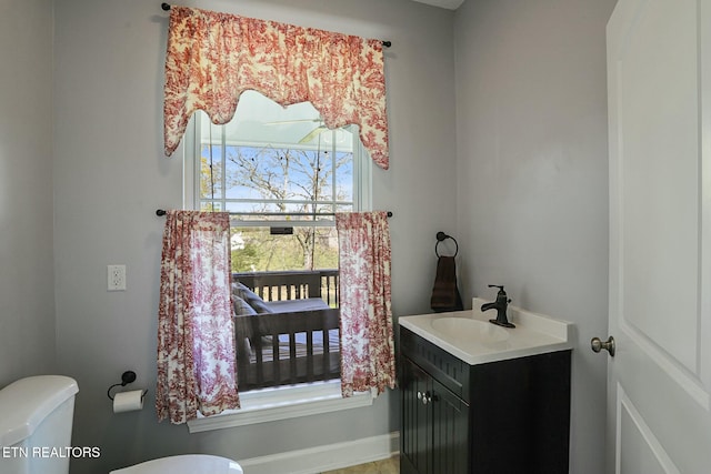 bathroom featuring toilet and vanity
