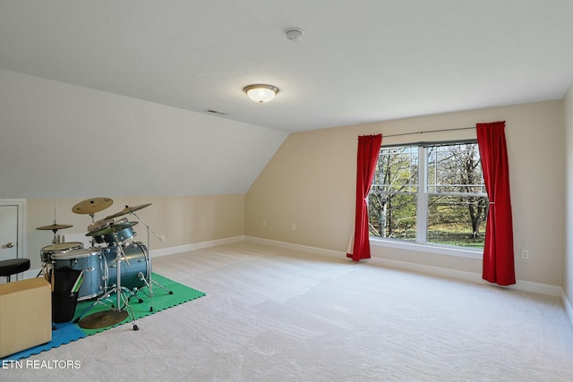 rec room featuring lofted ceiling, baseboards, visible vents, and light colored carpet