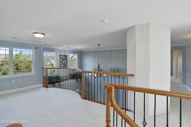 hall featuring an upstairs landing, baseboards, ornamental molding, and light colored carpet