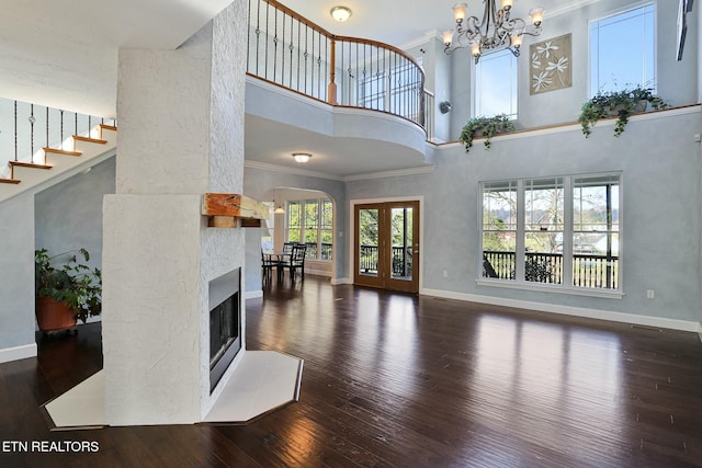 living room with crown molding, baseboards, dark wood-style flooring, and french doors